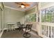 Screened porch with seating area and views of the woods at 1551 Spinnaker Dr. # 5822, North Myrtle Beach, SC 29582