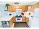 Well-equipped kitchen with light wood cabinets and white appliances at 6302 Ocean Blvd. N # E-1, North Myrtle Beach, SC 29582