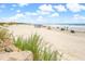 Sandy beach with ocean waves and people at 6302 Ocean Blvd. N # E-1, North Myrtle Beach, SC 29582