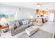 Open living room and kitchen with comfy seating and coastal decor at 6302 Ocean Blvd. N # E-1, North Myrtle Beach, SC 29582
