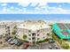 Oceanfront condo building with parking and surrounding homes at 6302 Ocean Blvd. N # E-1, North Myrtle Beach, SC 29582
