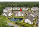 Aerial view of condo building, highlighting its location near a pond and other buildings at 5882 Longwood Dr. # 204, Murrells Inlet, SC 29576