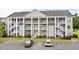 Two-story condo building with ample parking and landscaping at 5882 Longwood Dr. # 204, Murrells Inlet, SC 29576