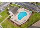 Community pool with lounge chairs and surrounding patio area at 5882 Longwood Dr. # 204, Murrells Inlet, SC 29576