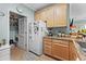 Well-equipped kitchen with light wood cabinets, refrigerator, and pantry at 5882 Longwood Dr. # 204, Murrells Inlet, SC 29576
