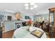 Bright dining area with a round table and chairs, hardwood floors, and access to the kitchen at 5882 Longwood Dr. # 204, Murrells Inlet, SC 29576