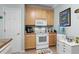 White appliances and light wood cabinets in this well-lit kitchen at 5882 Longwood Dr. # 204, Murrells Inlet, SC 29576