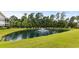 Picturesque pond view with lush landscaping and fountain feature at 5882 Longwood Dr. # 204, Murrells Inlet, SC 29576