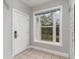 Bright entryway with tile flooring, white door, and a large window offering a view of trees at 1009 World Tour Blvd. # 301, Myrtle Beach, SC 29579
