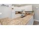 Kitchen boasts granite countertops and white cabinetry, offering ample counter space at 1009 World Tour Blvd. # 301, Myrtle Beach, SC 29579