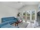 Living room with hardwood floors, blue sofas, and sliding doors leading to a balcony at 1009 World Tour Blvd. # 301, Myrtle Beach, SC 29579
