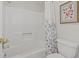 Clean bathroom with shower/tub, toilet, and floral shower curtain at 110 Hartland Dr. # 15-E, Myrtle Beach, SC 29572