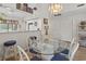 Dining area with glass-top table and chairs, open to the kitchen at 110 Hartland Dr. # 15-E, Myrtle Beach, SC 29572