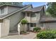 Gray siding condo building with stairs, landscaping, and a walkway at 110 Hartland Dr. # 15-E, Myrtle Beach, SC 29572