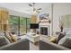Living room with fireplace, TV, and sliding glass doors to deck at 110 Hartland Dr. # 15-E, Myrtle Beach, SC 29572