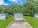 Rear view of mobile home, showing access ramp and yard at 300 Saint Christopher Circle, Pawleys Island, SC 29585