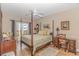 Main bedroom with a post bed and access to balcony at 4516 N Plantation Harbour Dr. # H-12, Little River, SC 29566