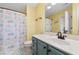 Bathroom with teal vanity and an ocean-themed shower curtain at 117B Ocean Blvd. S, Surfside Beach, SC 29575