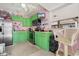 Beach-themed kitchen with green cabinets and stainless steel appliances at 117B Ocean Blvd. S, Surfside Beach, SC 29575