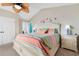 Bright bedroom with king bed, colorful bedding, and ceiling fan at 117B Ocean Blvd. S, Surfside Beach, SC 29575