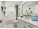 Modern bathroom with white vanity, bathtub, and decorative plants at 512 9Th Ave. S, North Myrtle Beach, SC 29582