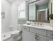 Clean bathroom with white tiled shower, vanity, and gold fixtures at 512 9Th Ave. S, North Myrtle Beach, SC 29582