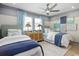 Two twin beds in a bedroom with a ceiling fan and light, a rug, matching lamps, and beach-themed decor at 512 9Th Ave. S, North Myrtle Beach, SC 29582