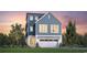 Charming two-story home with a blue exterior, white garage door, and landscaped yard at 512 9Th Ave. S, North Myrtle Beach, SC 29582