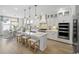 Modern white kitchen featuring gold accents, an island with seating, and stainless steel appliances at 512 9Th Ave. S, North Myrtle Beach, SC 29582