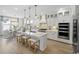 Spacious open-concept kitchen and dining area with white cabinetry, large island, and modern appliances at 512 9Th Ave. S, North Myrtle Beach, SC 29582