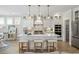 Elegant kitchen featuring white cabinetry, an island with seating, and double ovens at 512 9Th Ave. S, North Myrtle Beach, SC 29582