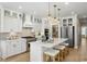 Bright white kitchen with gold fixtures, a pantry, and an island with seating at 512 9Th Ave. S, North Myrtle Beach, SC 29582