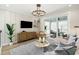 Cozy living room with sliding glass doors leading to a balcony, a large chandelier, and comfortable seating at 512 9Th Ave. S, North Myrtle Beach, SC 29582