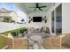 Outdoor living space with a fire pit, comfortable seating, a TV, and a fenced backyard at 512 9Th Ave. S, North Myrtle Beach, SC 29582