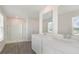 Double vanity bathroom with a large shower and gray vinyl plank flooring at 831 Buttonwood Dr., Conway, SC 29527