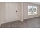 Bright entryway with neutral gray vinyl plank flooring and white door at 831 Buttonwood Dr., Conway, SC 29527