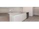 Island kitchen with white cabinets, granite countertops, and stainless steel dishwasher at 831 Buttonwood Dr., Conway, SC 29527