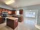 Kitchen with wood cabinets, stainless steel appliances, center island, and tile floors at 574 Ramblewood Circle, Little River, SC 29566