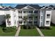 Attractive three-story condo building with palm trees and landscaping at 616 River Oaks Dr. # 54F, Myrtle Beach, SC 29579