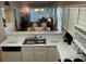 View of the kitchen from the dining area with white cabinets and appliances at 616 River Oaks Dr. # 54F, Myrtle Beach, SC 29579