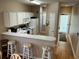 Kitchen with white appliances, breakfast bar, and ample counter space at 616 River Oaks Dr. # 54F, Myrtle Beach, SC 29579
