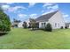 View of the backyard showing a home's exterior and patio at 794 Thistle Trail, Calabash, NC 28467