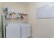 Laundry room with washer, dryer, shelving and a monthly calendar at 794 Thistle Trail, Calabash, NC 28467