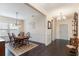 Bright dining room features a table with four chairs and a chandelier at 794 Thistle Trail, Calabash, NC 28467