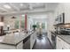 Open kitchen with granite island, stainless steel appliances, and hardwood floors at 794 Thistle Trail, Calabash, NC 28467