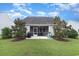House exterior with a screened porch and well-maintained lawn at 794 Thistle Trail, Calabash, NC 28467