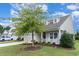 Charming two-story home with landscaping and large tree at 794 Thistle Trail, Calabash, NC 28467