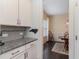 White kitchen cabinets and granite countertops, view into dining room at 794 Thistle Trail, Calabash, NC 28467