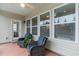 Cozy screened porch with wicker chairs and potted plants at 794 Thistle Trail, Calabash, NC 28467