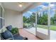 Relaxing screened porch with patio furniture and view of the backyard at 794 Thistle Trail, Calabash, NC 28467